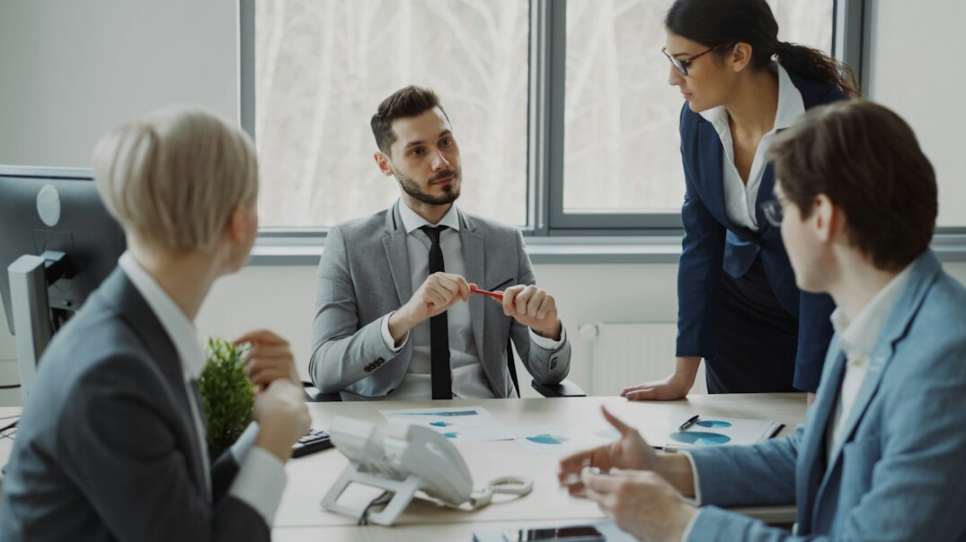 business manager leading team meeting